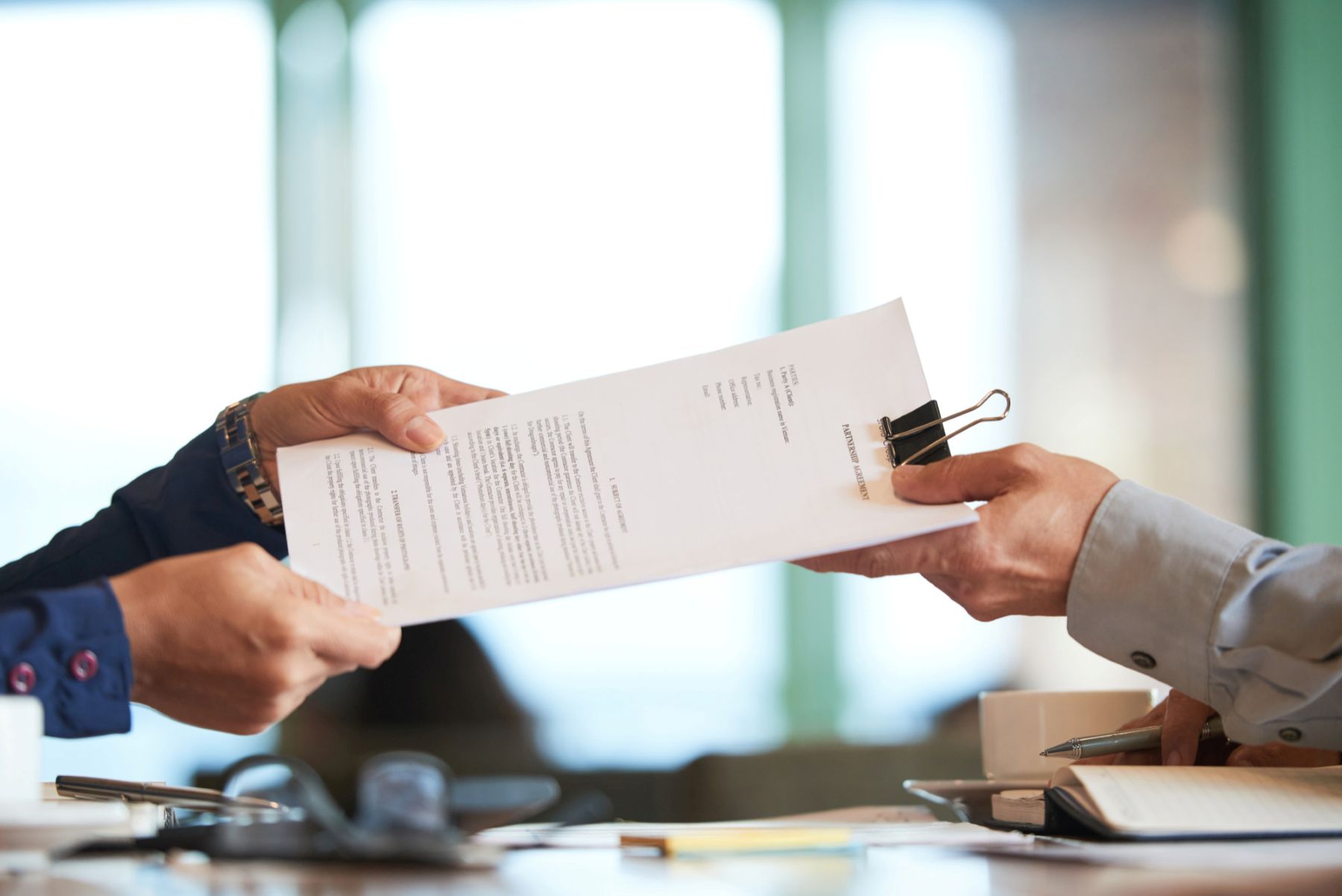 Office worker hands over documents